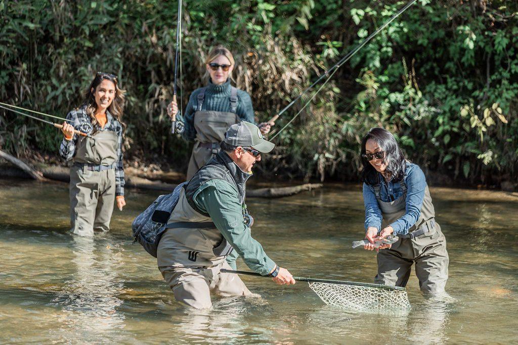 a group of friends catching a fish